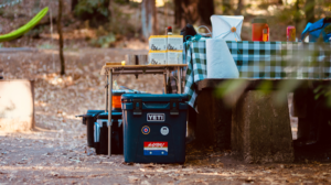 Foldable Camping Table next to Picnic Table and Coolers